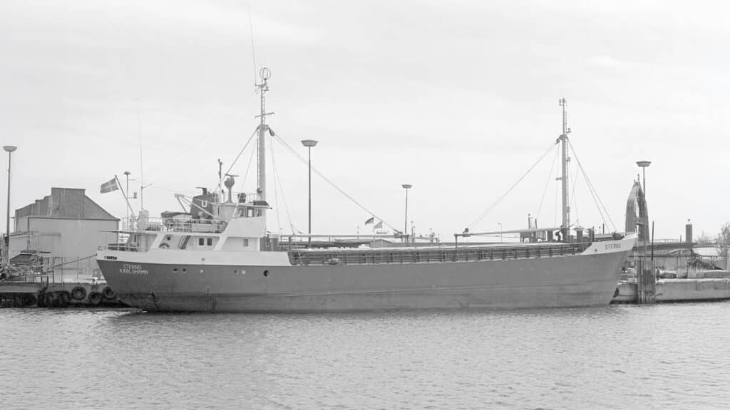 An older coaster from the fleet lying alongside, photographed in black and white